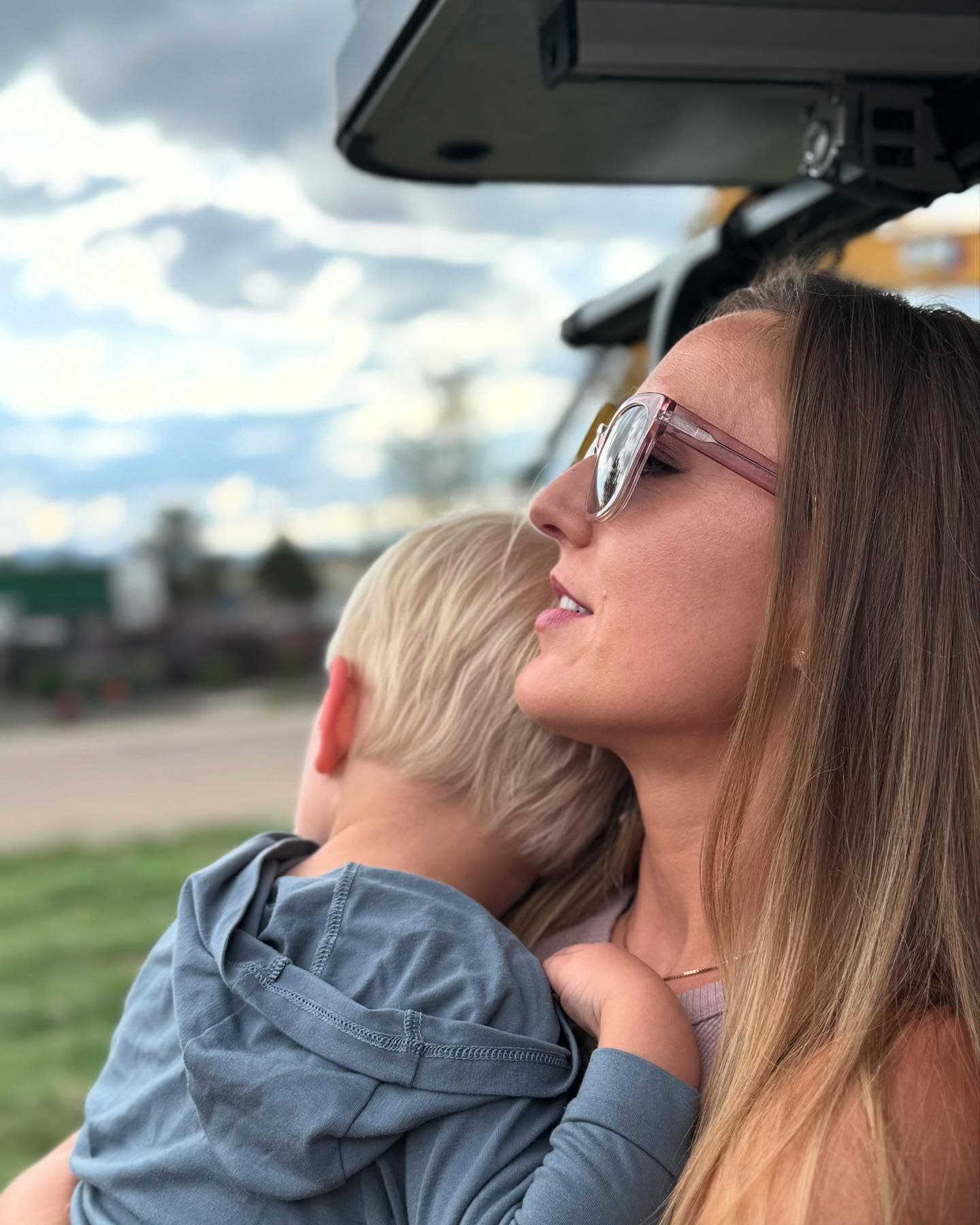 Aubrielle holding her son outdoors