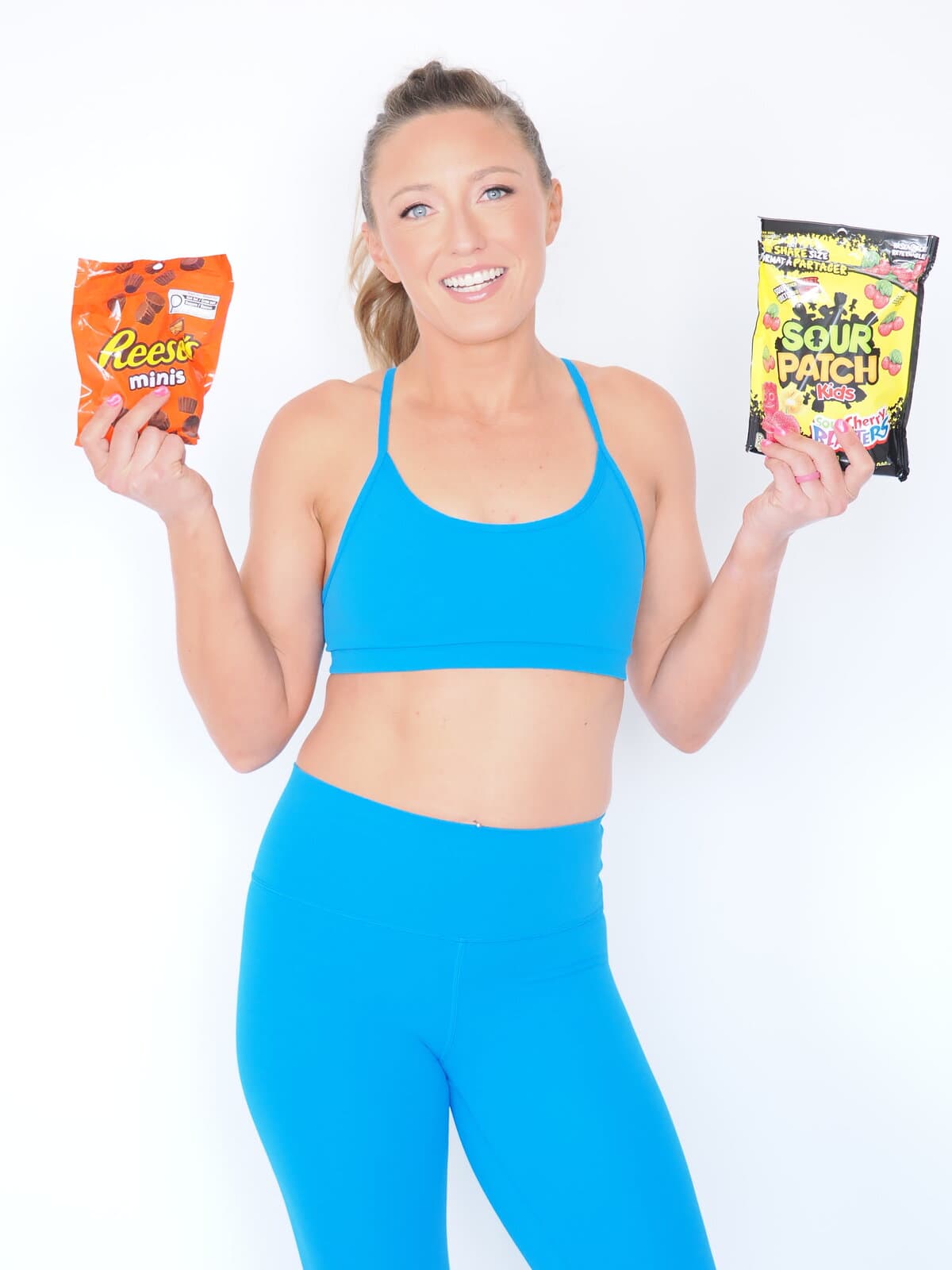 Aubrielle holding bags of Reese's and Sour Patch Kids — no foods are off-limits